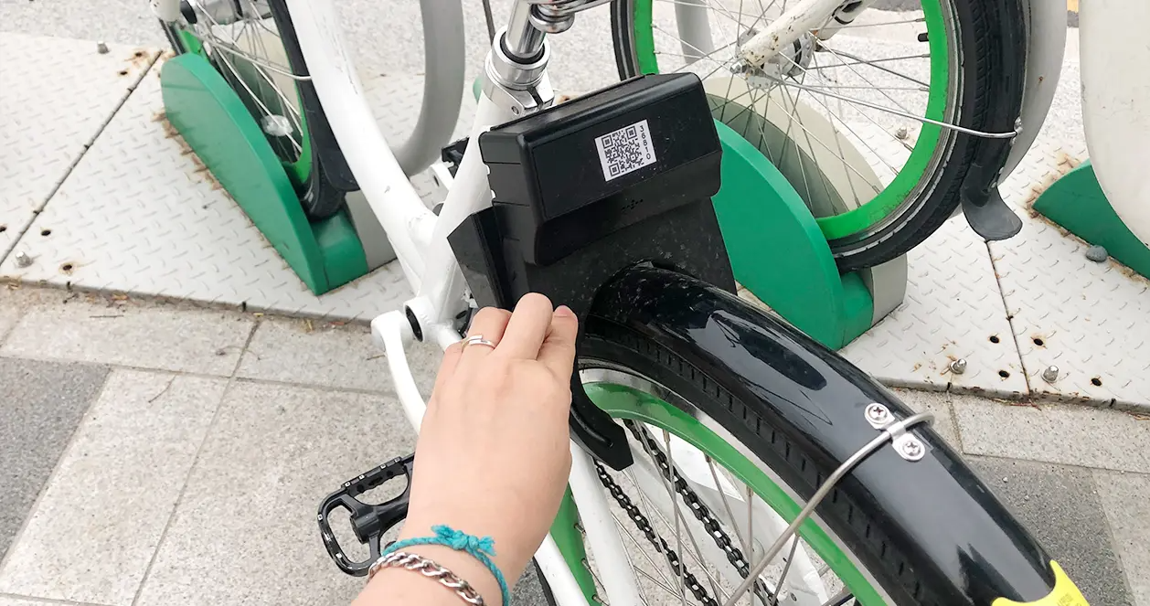 Returning Ddareungi bike securely at the station in Seoul, emphasizing easy lock system to end rental journey safely.