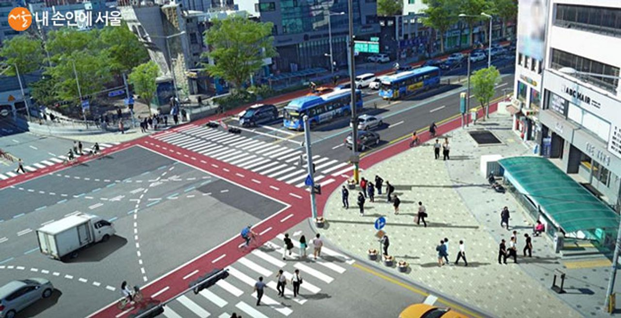 首尔市中心的繁忙十字路口，交织着通红的自行车道，展示了城市规划中的创新设计，旨在促进安全的骑行环境。