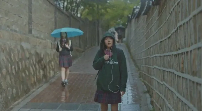Goblin drama scene showing schoolgirl on stone path by Deokseong Girls' High School.