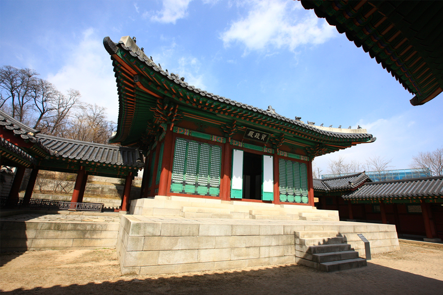 Gyeongbokgung Palace with vibrant surrounding gardens in full bloom.