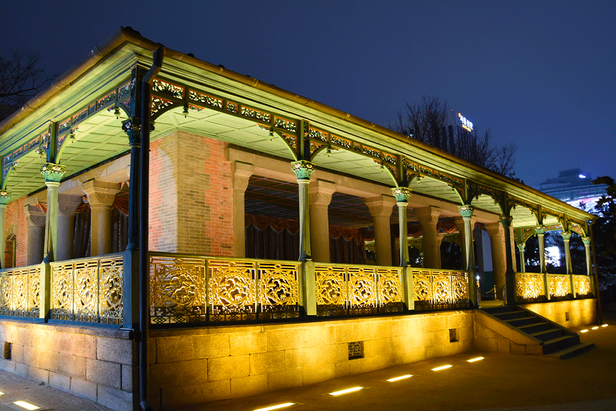 Night view of Jeonggwanheon Pavilion illuminated beautifully in Deoksugung Palace.