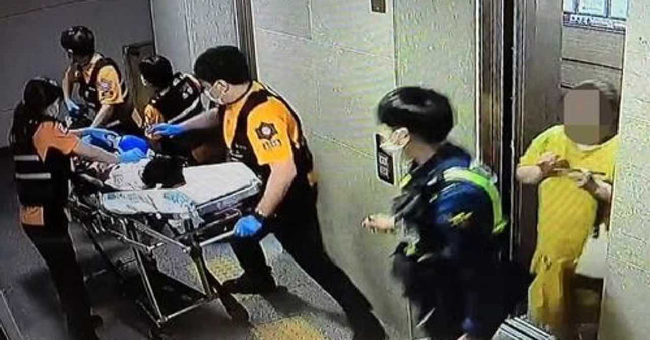 急救人员在电梯中运送病人，体现紧急医疗响应与合作。