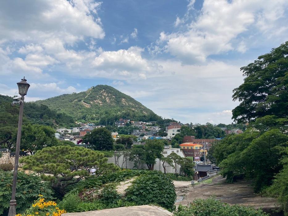 Seokpajeong Seoul Museum in Buam-dong with traditional hanok architecture surrounded by trees and the Inwangsan mountain backdrop