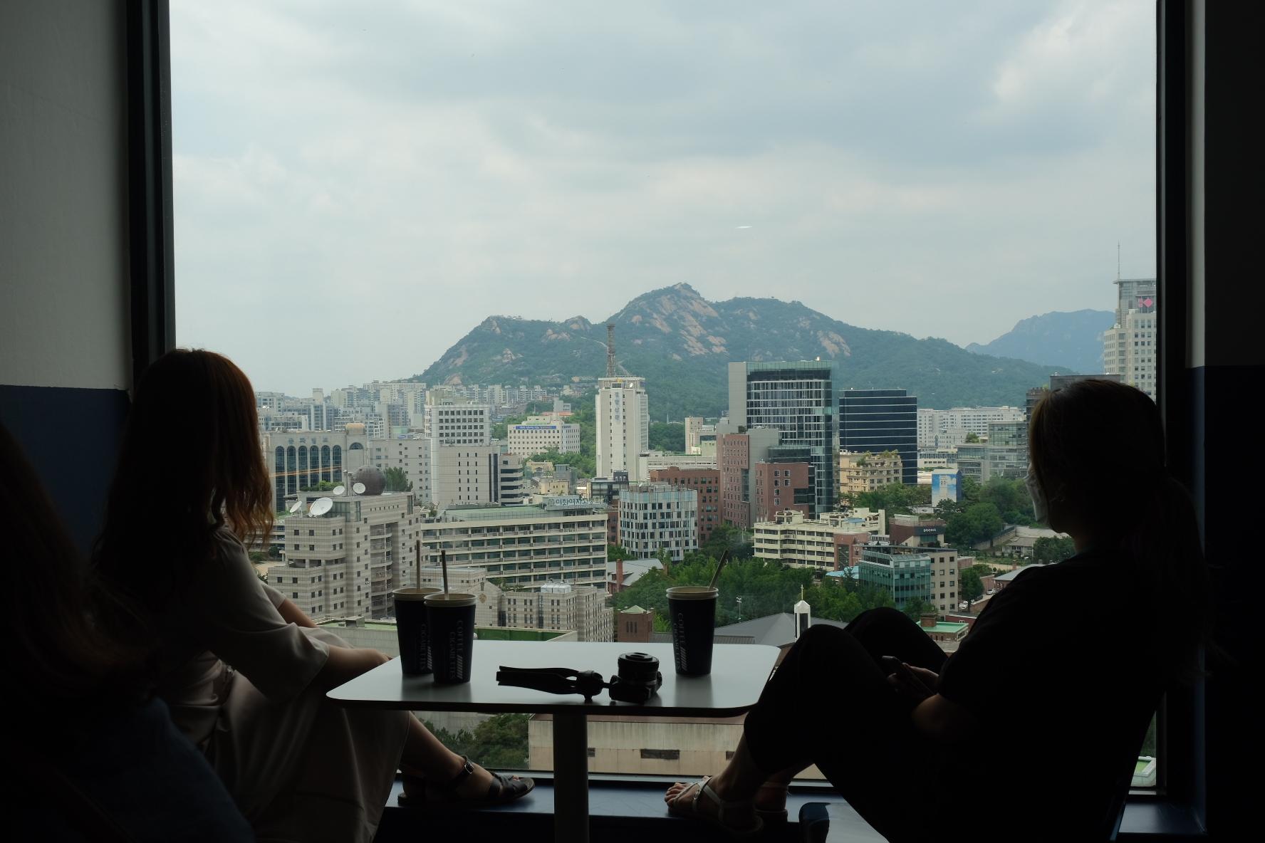 Take In The Stunning View Of The Mountains And The City At This High-Storey Cafe | Coffee And Cigarette | Seoul City Hall