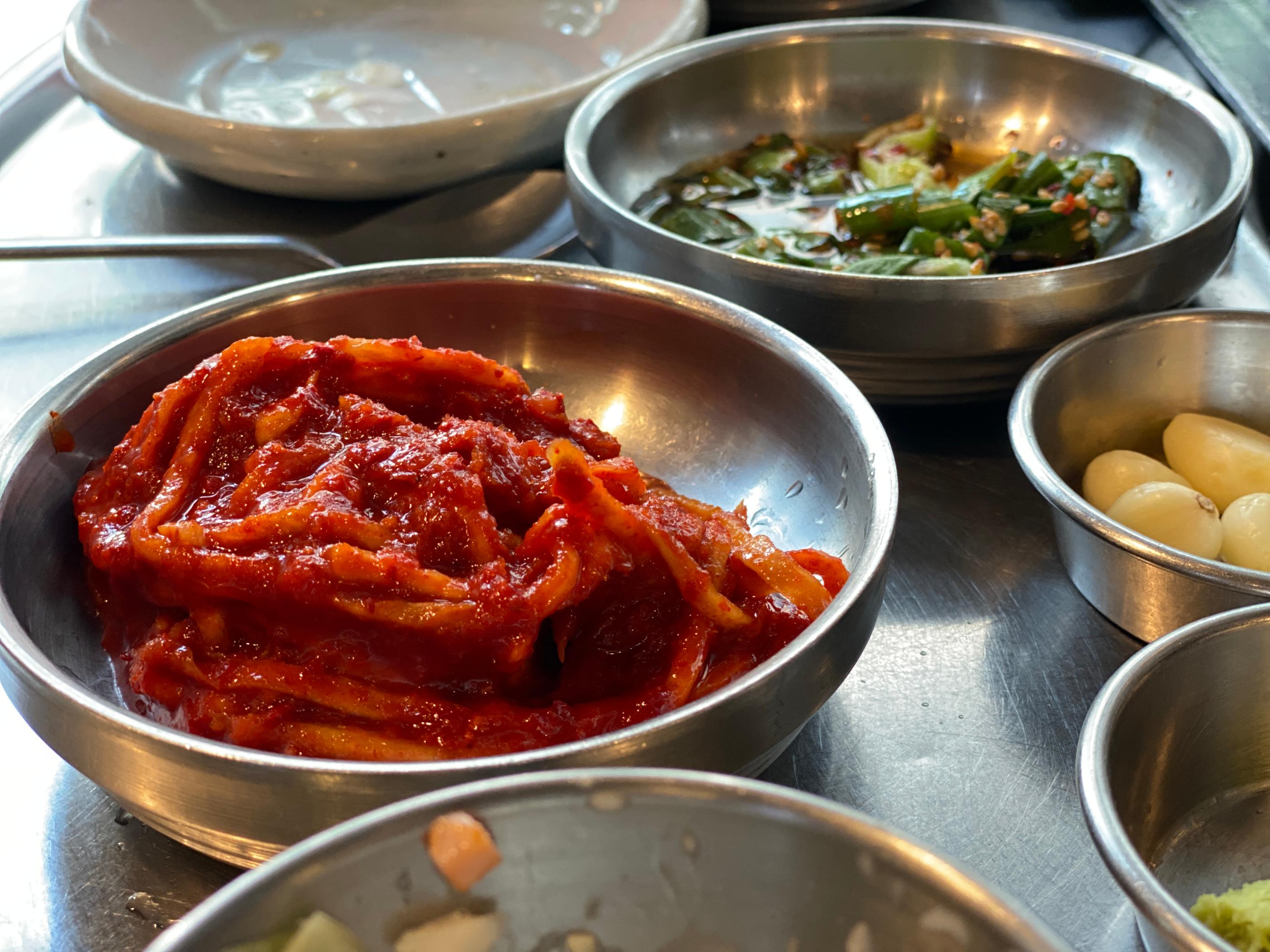 ドゥトゥムで提供されるムチェキムチと他のおかず。色鮮やかで食慾をそそる韓国料理の代表的なサイドディッシュです。