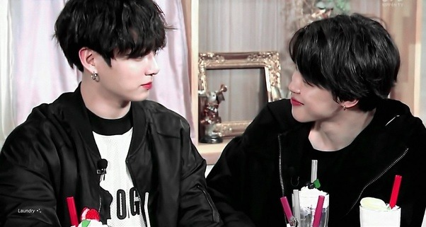 ชายหนุ่มสองคนสนทนากันในโอกาสที่เป็นกันเอง ซึ่งบริเวณโต๊ะที่มีเครื่องดื่มวางอยู่