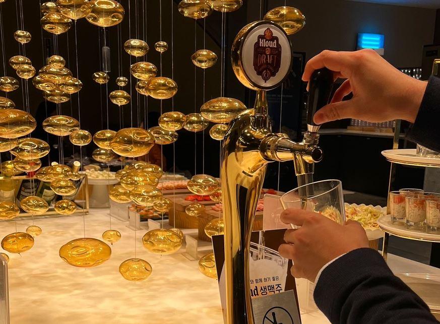 VIPSのビールディスペンサーでビールを注いでいる場面