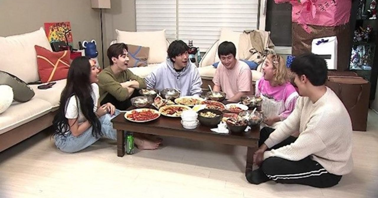 韓國家庭聚會，大家愉快地圍坐在一起，享受豐盛的韓國料理和温馨的家庭時光。