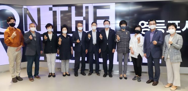 多名穿西裝的官員站在永登浦市場站的宣傳屏幕前,紀念文化藝術鐵道的開幕。
