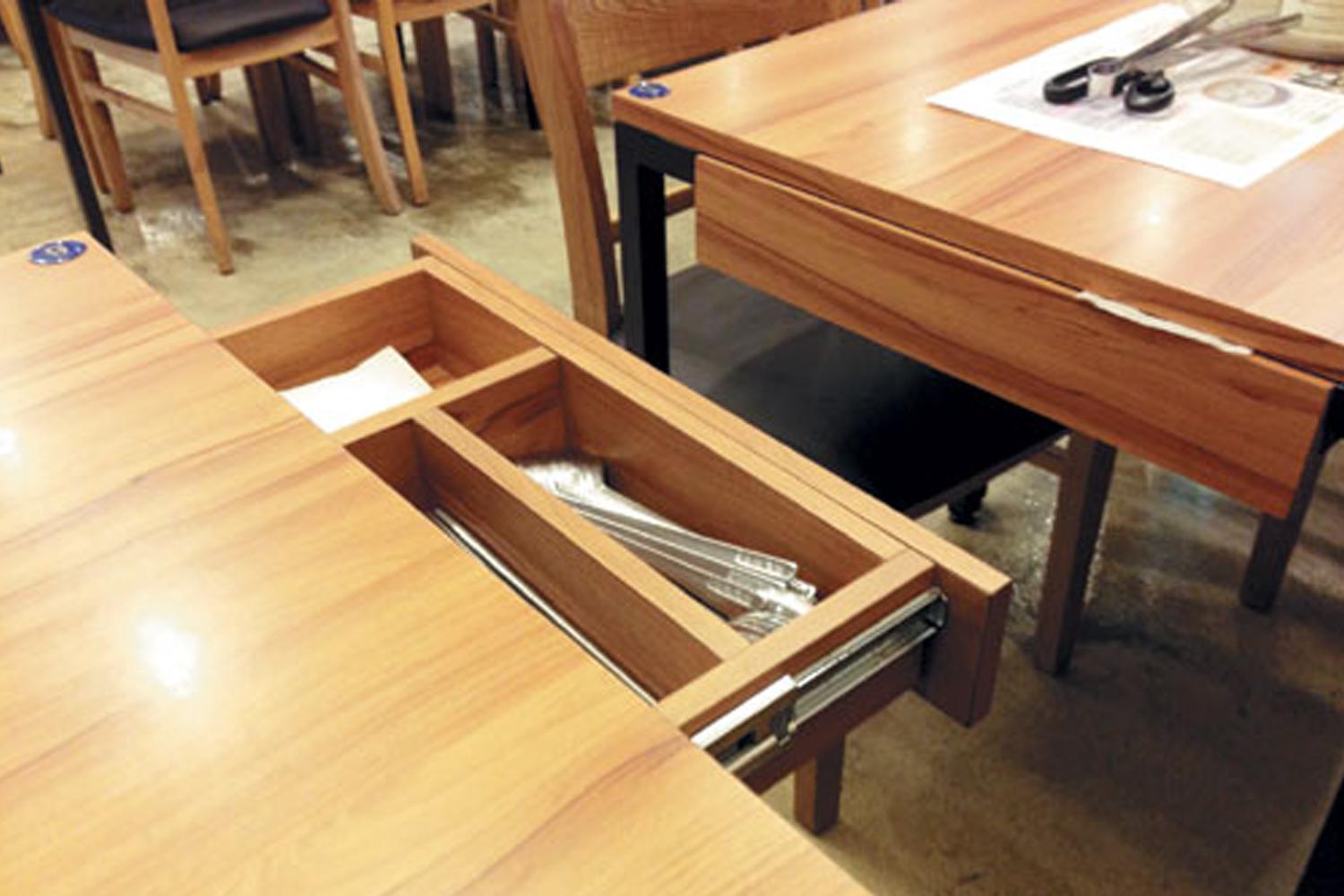韓國餐廳桌下的抽屜,裡面存放著餐具。