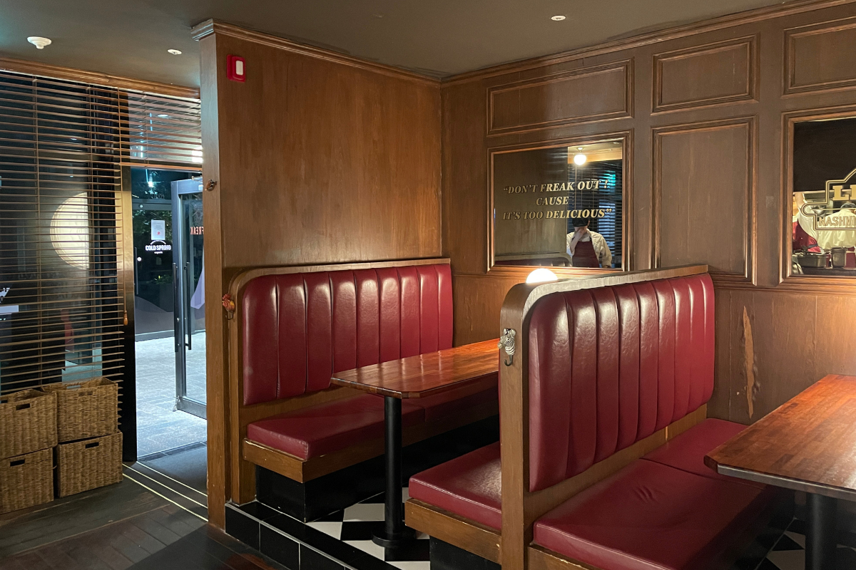 Zesty Saloon interior, designed with rustic wooden furniture and charming lighting, creating a trendy atmosphere for diners in Seongsu, Seoul.