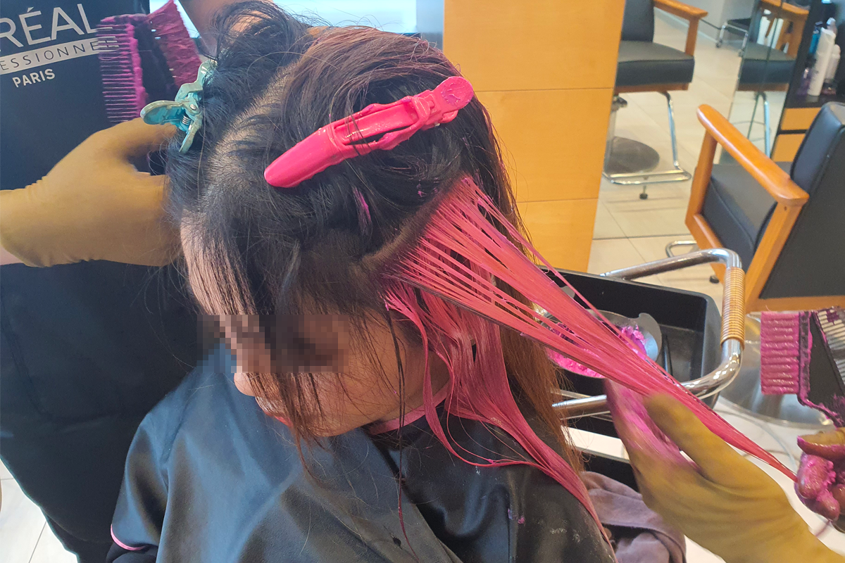 MERCY HAIR的美发师正在为顾客涂抹染发剂，颜色充满活力。