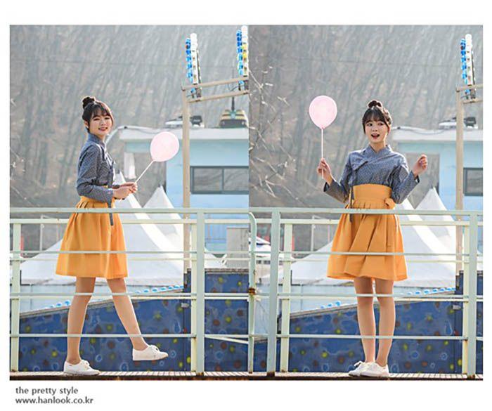 Woman in daily hanbok holding a balloon in an urban setting