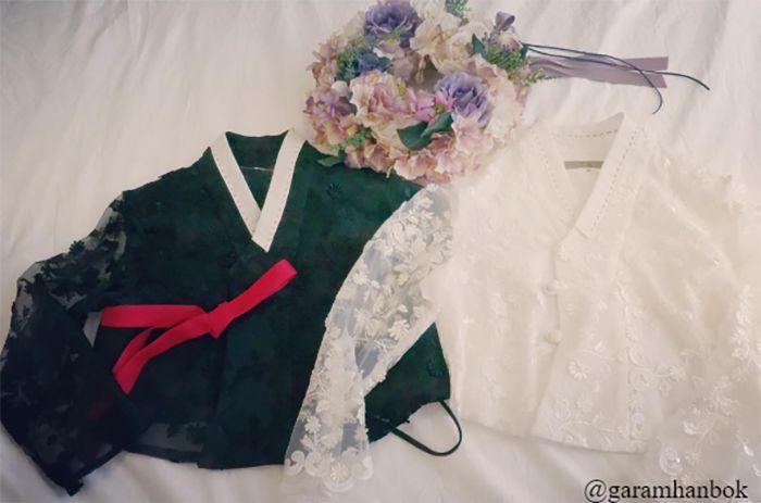 Hanging ensemble of ornate hanbok tops with intricate designs and flair