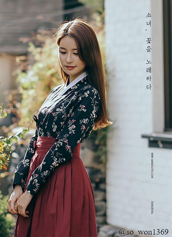 Elegant daily hanbok displayed in a boutique setting with floral design