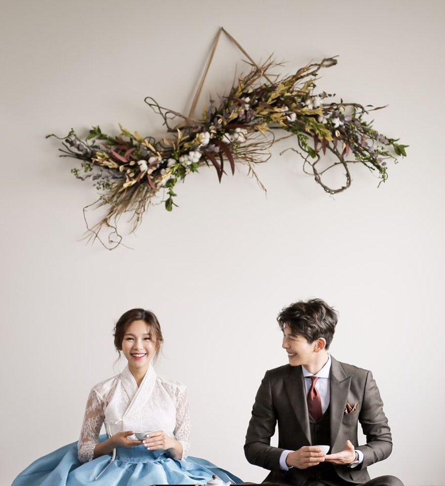 Intricate hanbok wedding dress in cream, blending traditional and contemporary styles