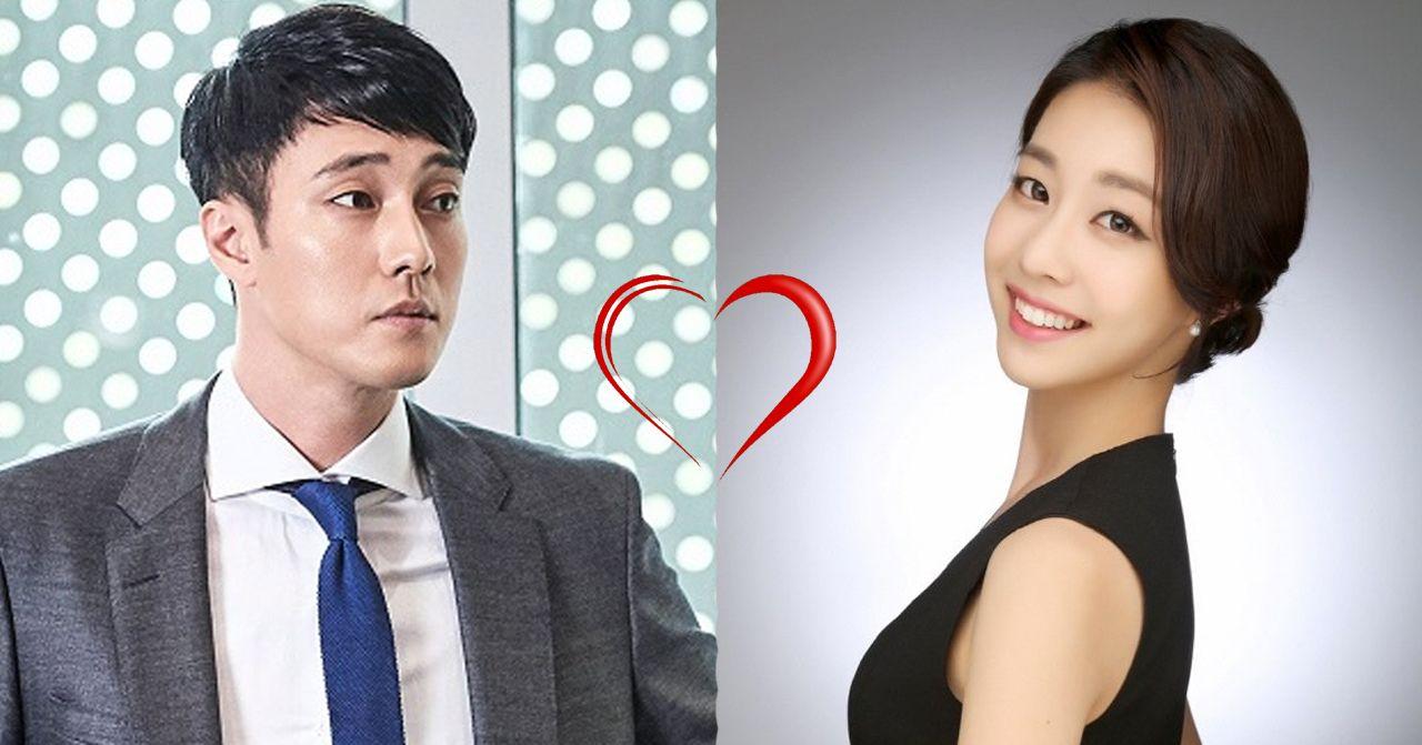 ภาพชายสวมชุดสูทสีเทา และหญิงสวมชุดเดรสสีดำ ทั้งคู่ยืนข้างกัน มีรูปหัวใจระหว่างกลาง เป็นการแสดงความรักและความใกล้ชิดระหว่างคู่รัก