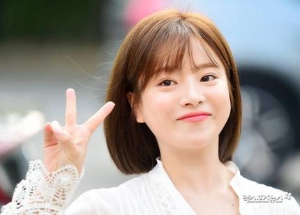 歌手ベンが、白いレースの服を着てピースサインをしている姿。自然な茶色の髪色が印象的です。