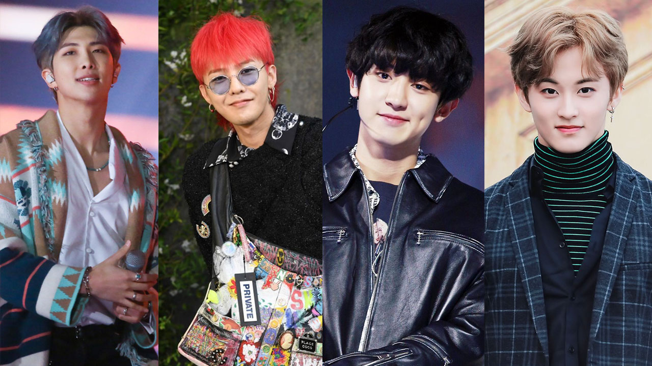 ภาพกลุ่มของสี่ไอดอลเกาหลี ผู้ชายในชุดที่โดดเด่นจากการเดินแบบและการแสดงดนตรีสด
