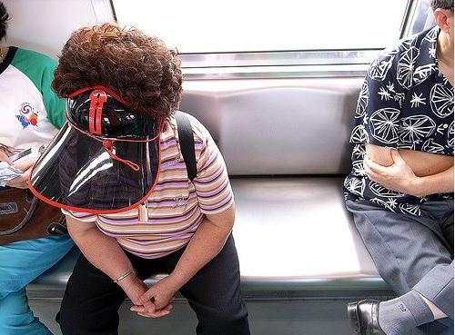 Ajumma wearing a sun visor, proudly sitting on the subway