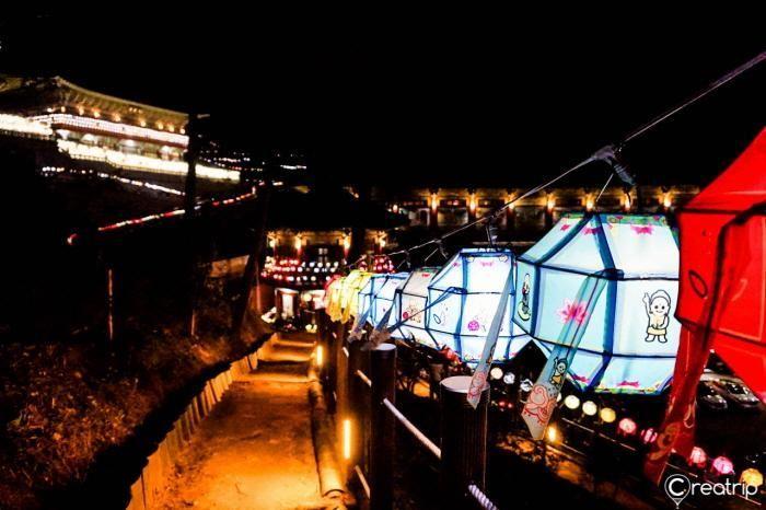 A colorful scene showcasing lanterns with intricate designs, illuminating the night sky at the festival.