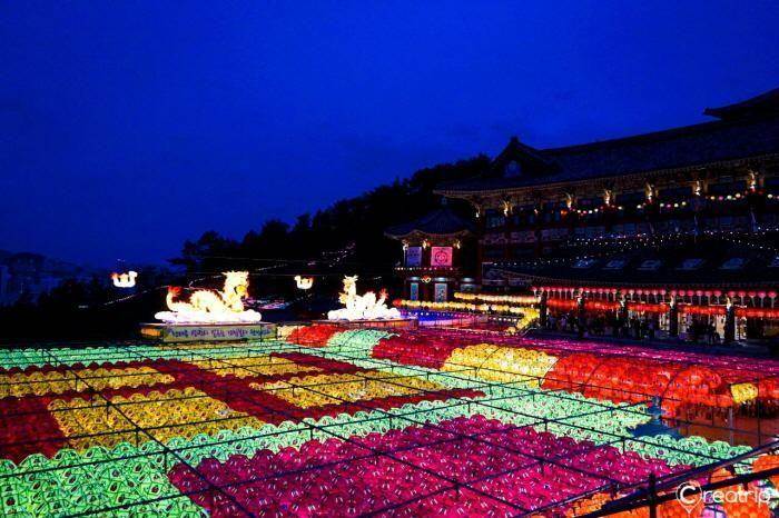 Rich decorations and glowing lanterns adorning the architecture of Samgwangsa Temple at night.