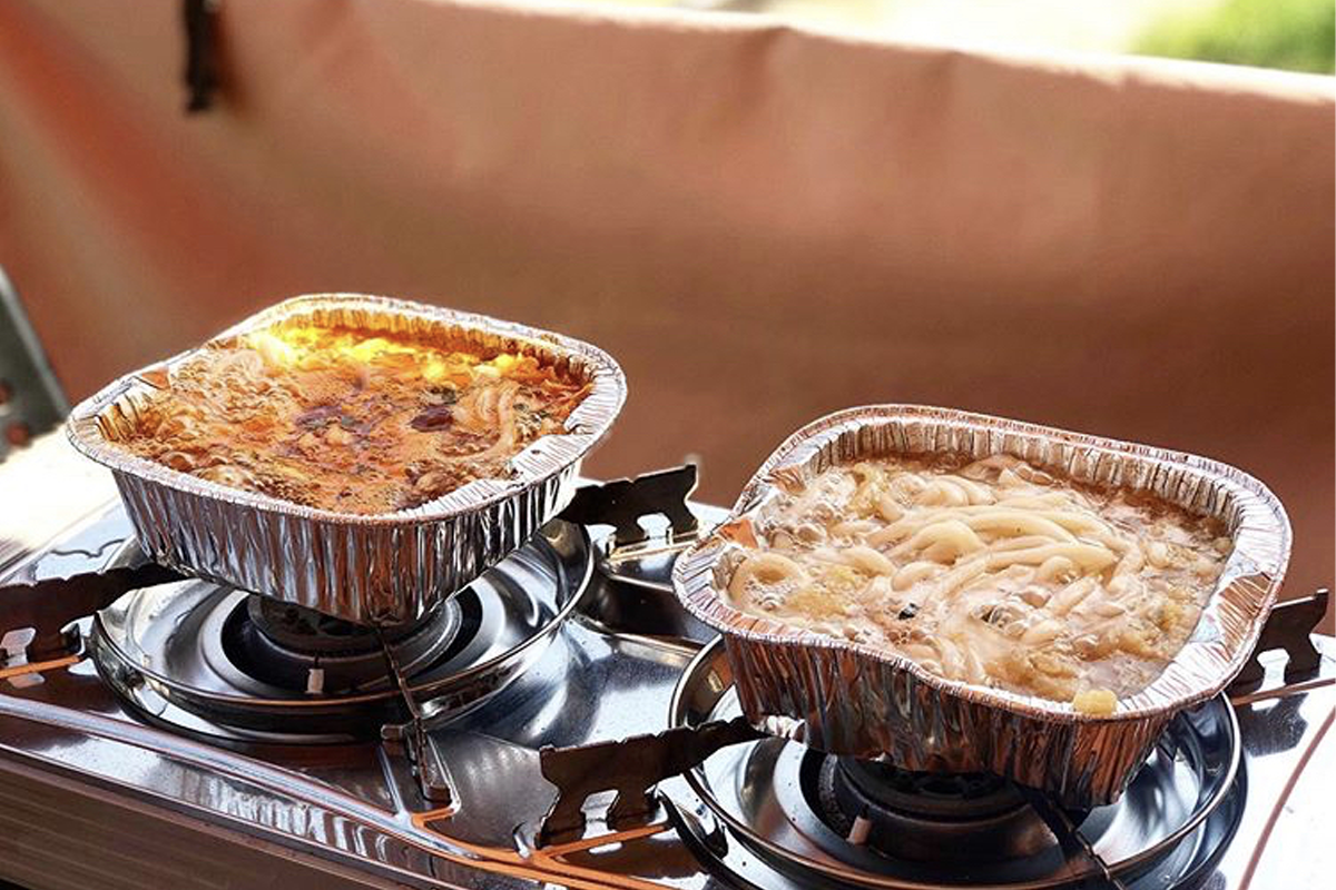 煮韓國公仔麵的場景，象徵韓國露營中的簡易美食準備。