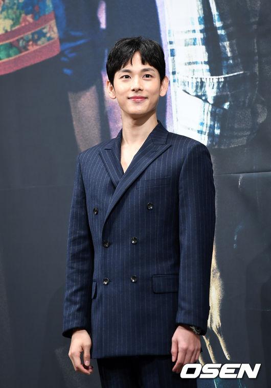 俳優イム・シワンがネイビーカラーのストライプスーツを着用し、半正式なイベントに参加している様子。