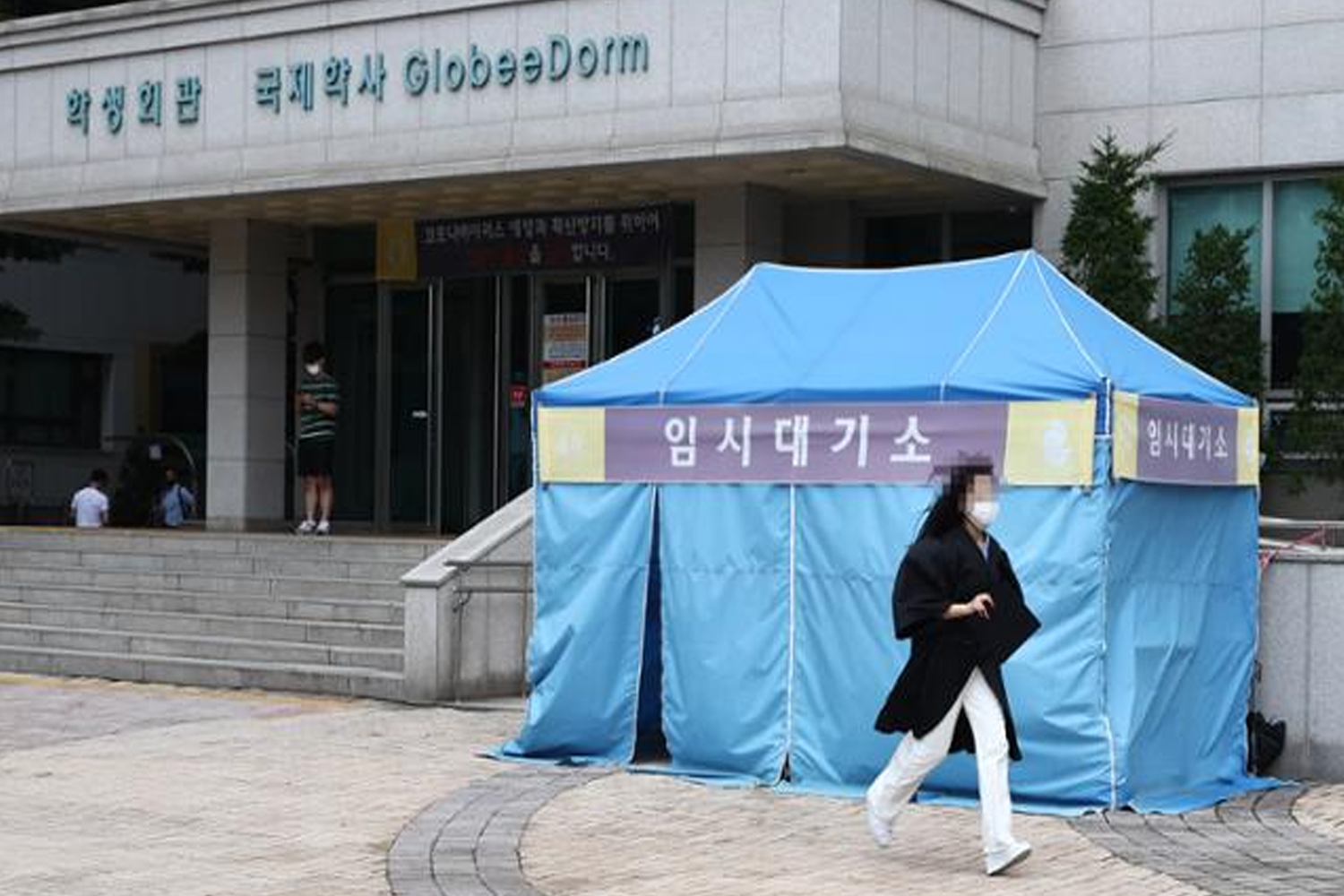 韓國外國語大學前的藍色帳篷，標示為臨時大螢幕，提供大學防疫現況。