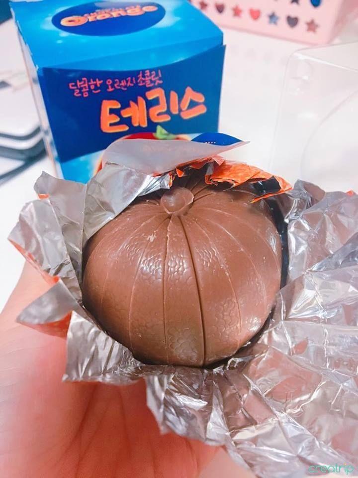 An unwrapped Terry's Chocolate Orange showing the chocolate segments resembling the shape of an orange inside the silver foil.