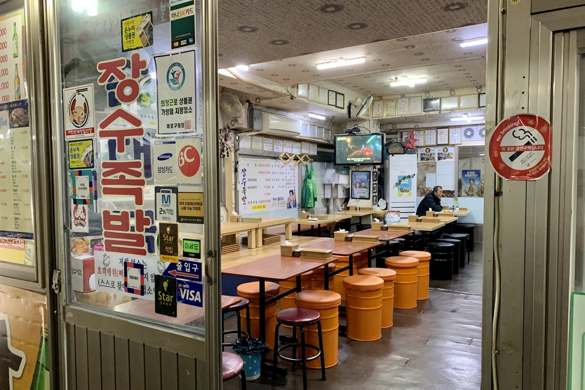 孔德市場的豬腳店一景，聚集了許多準備享用美食的人們