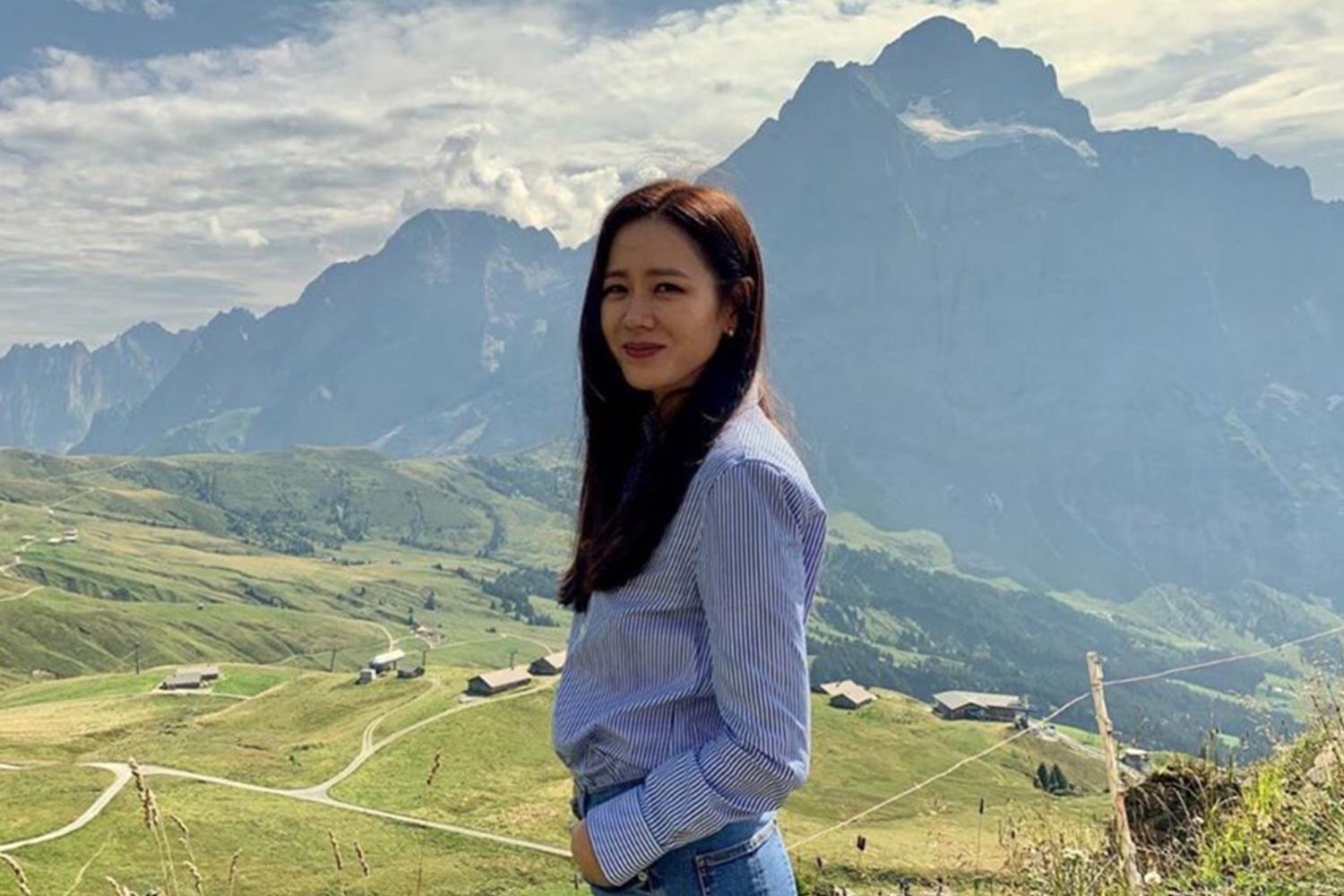 韓國演員孫藝珍在自然背景下進行户外拍攝，展現清新的形象。