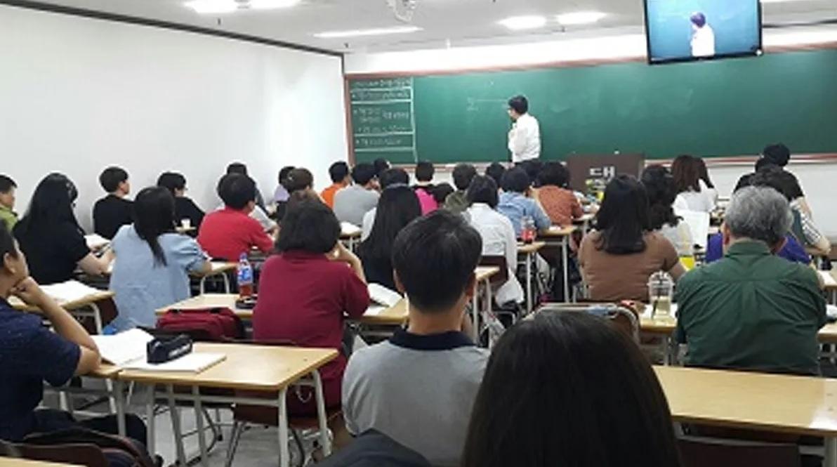 ห้องเรียนเต็มไปด้วยนักเรียนที่กำลังตั้งใจเรียนในห้องเรียนพิเศษของเกาหลี