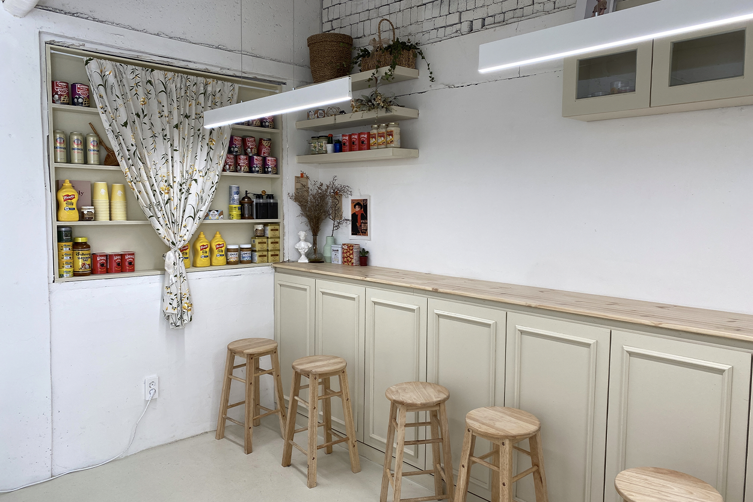 a long wooden table with stools at a cafe in daegu south korea