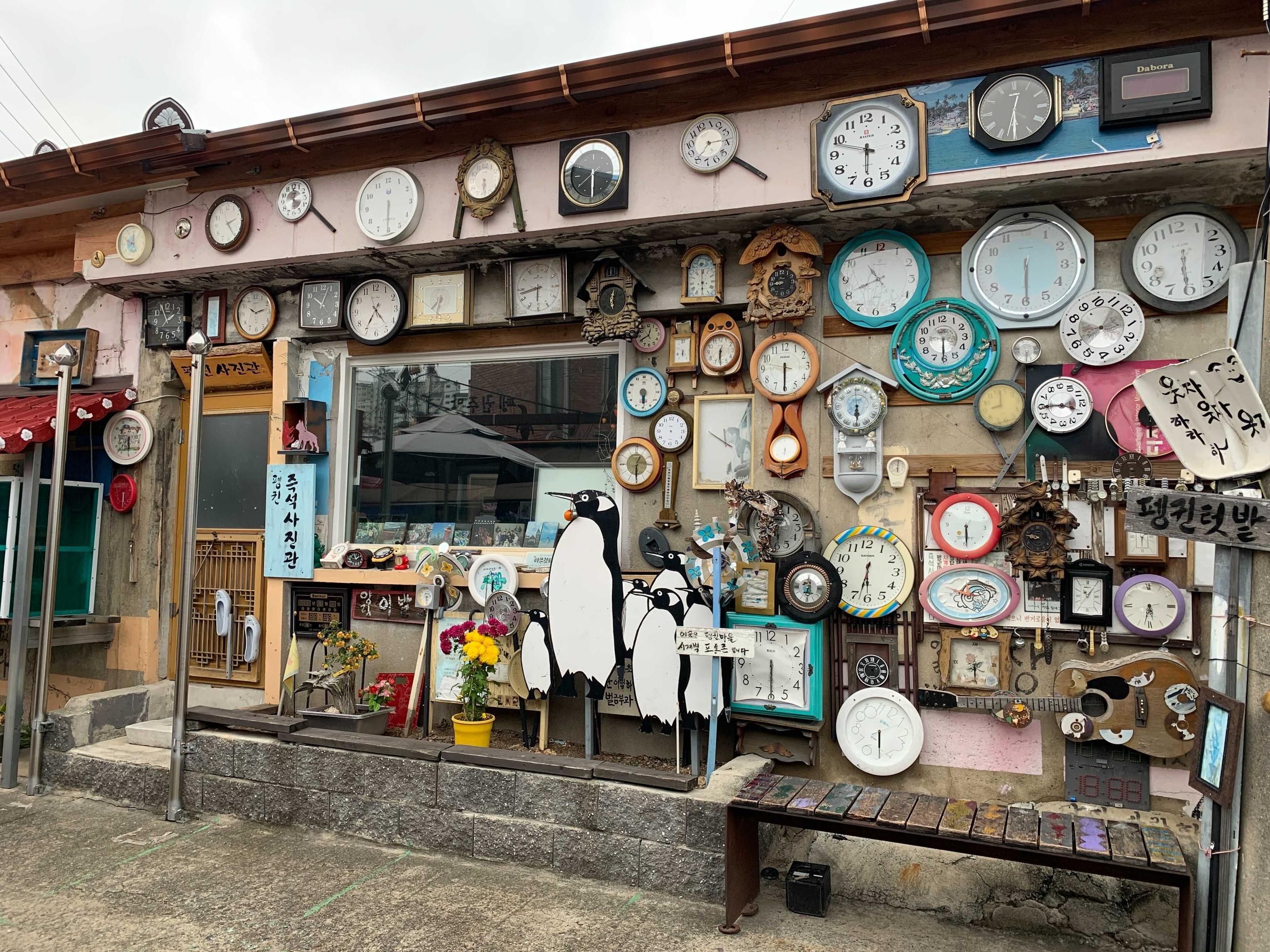 retro clocks on display on the wall in penguin village in gwangju