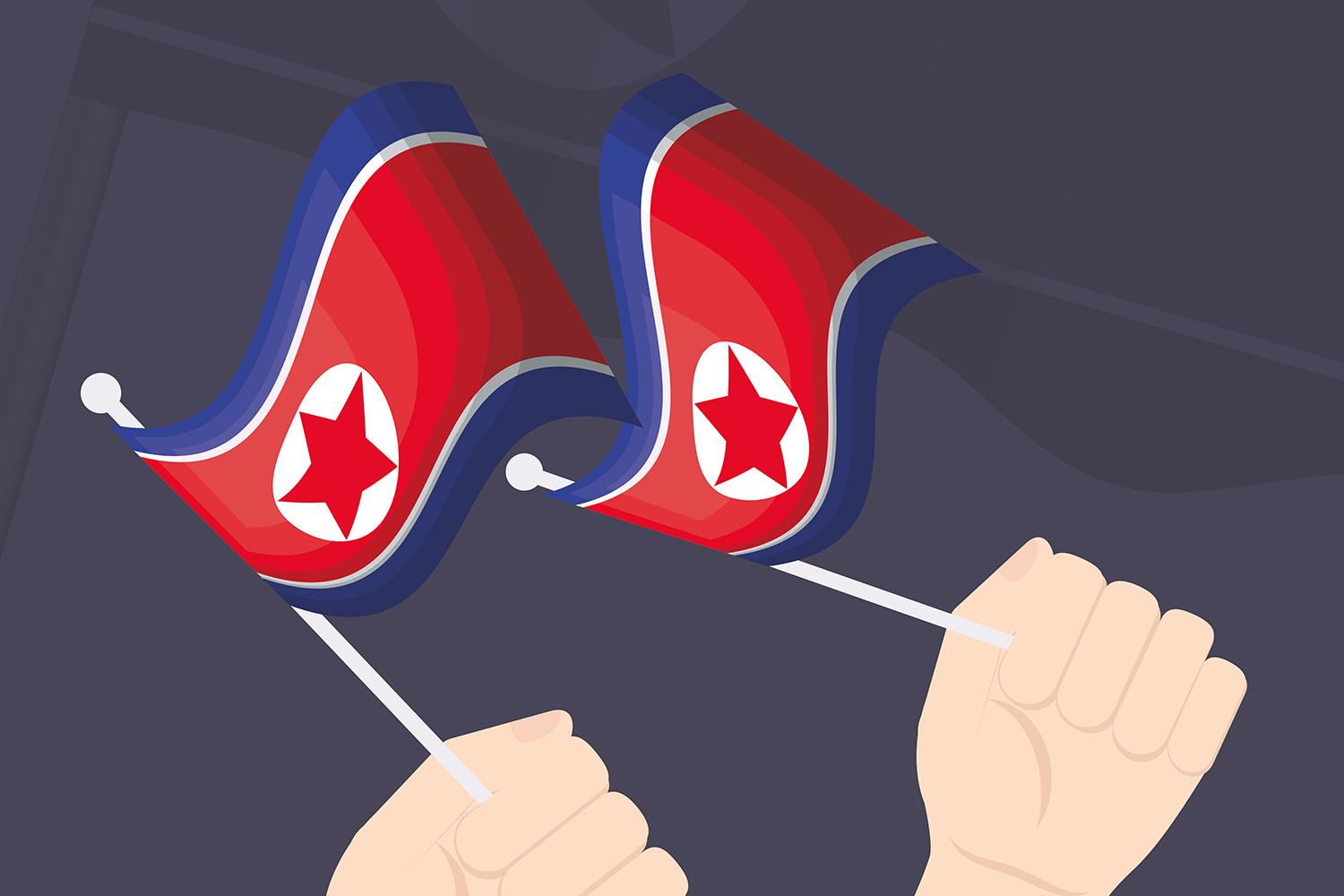 the north korean flags being held by two hands