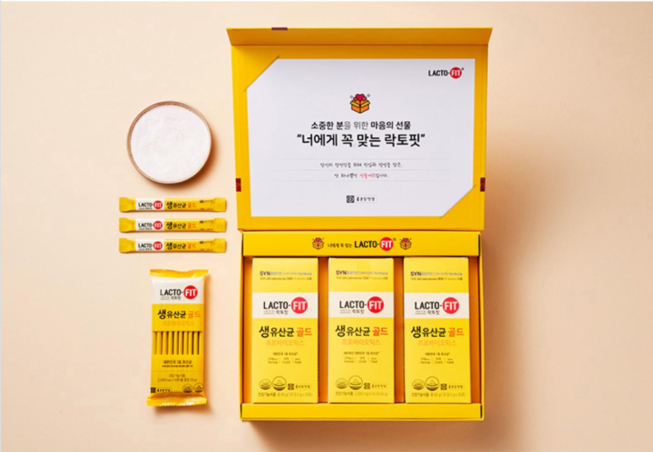 香港中環鐘根堂Lacto-Fit益生菌禮盒內部展示,排列整齊的益生菌產品和説明,背景為淺橙色牆面。