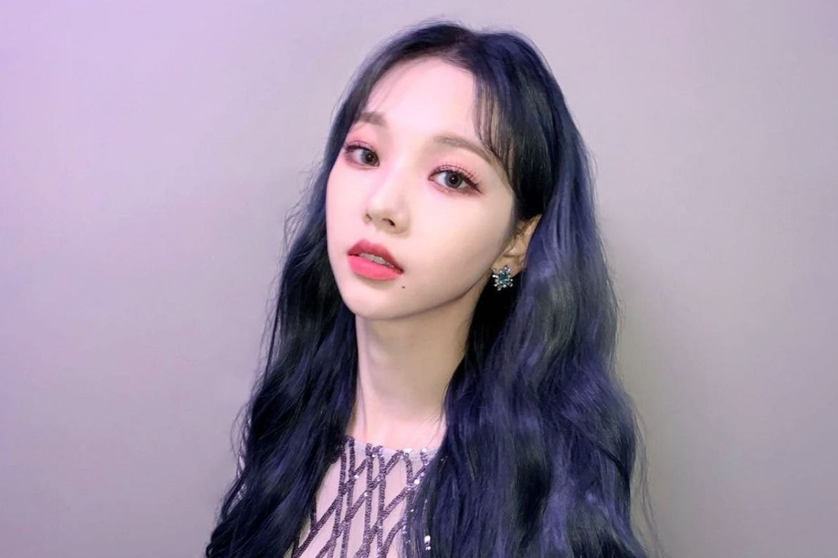 韓國女明星淺笑著半握住檸檬,襯衫線條簡約,背景是淺藍色牆,給人清新愉悦的感覺。