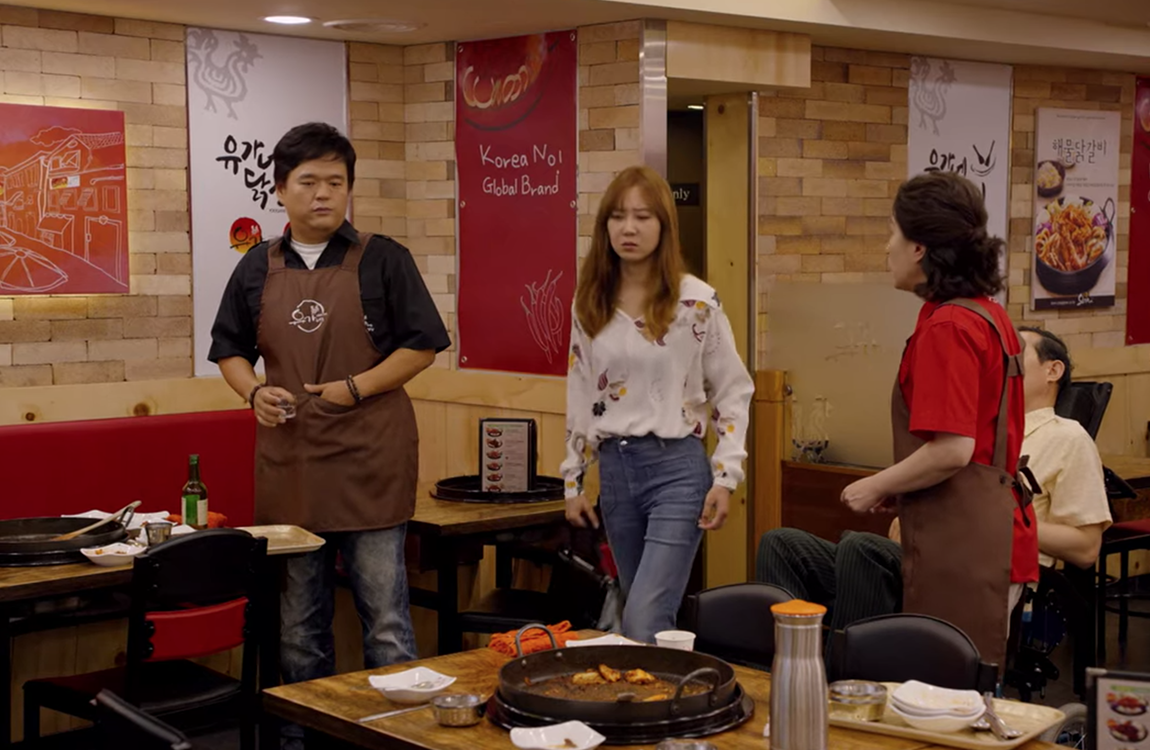 yoogane dakgalbi - inside with dakgalbi grill and tables with soju bottles