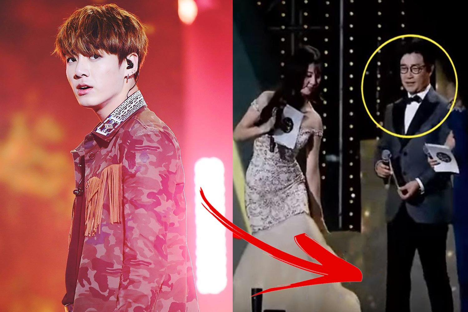 จองกุก BTS สวมใส่เสื้อแจ๊กเก็ตลายพรางขณะที่ยืนบนเวทีด้วยแสงสีชมพูในคอนเสิร์ตหนึ่ง