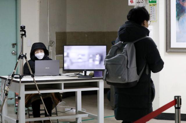 ソウルの景福高校で体温検査を受ける学生。新型コロナウイルス感染症の拡大を防ぐための措置の一環で、多くの受験生がこの検査を経て考査場に向かっています。最近、首都圏で記録的な数の感染者が確認され、防疫措置が強化されています。