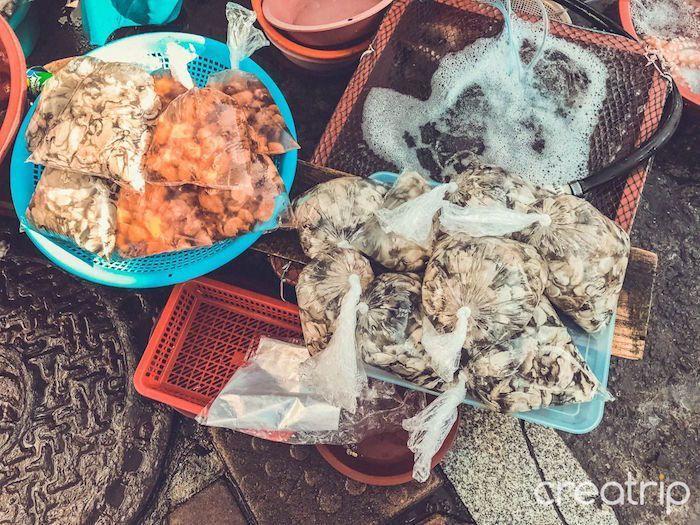 Bags of assorted seafood including shellfish and octopus sold in Tongyeong's market.