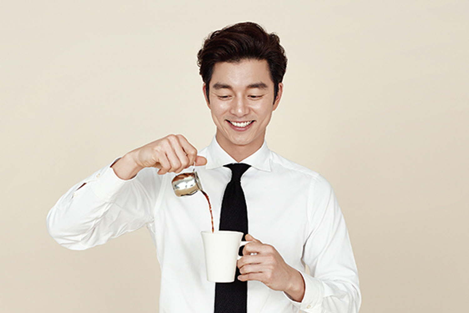 咖啡廣告，模特穿著白色襯衫和黑色領帶，正往白色杯中倒咖啡。