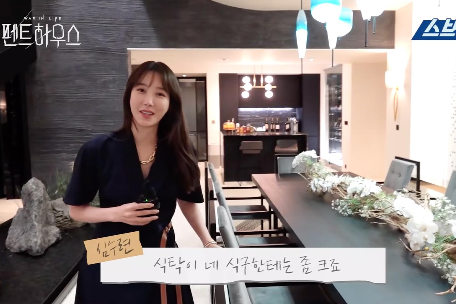 The kitchen and dining area of the luxurious penthouse apartment in a korean drama with a black and white color scheme