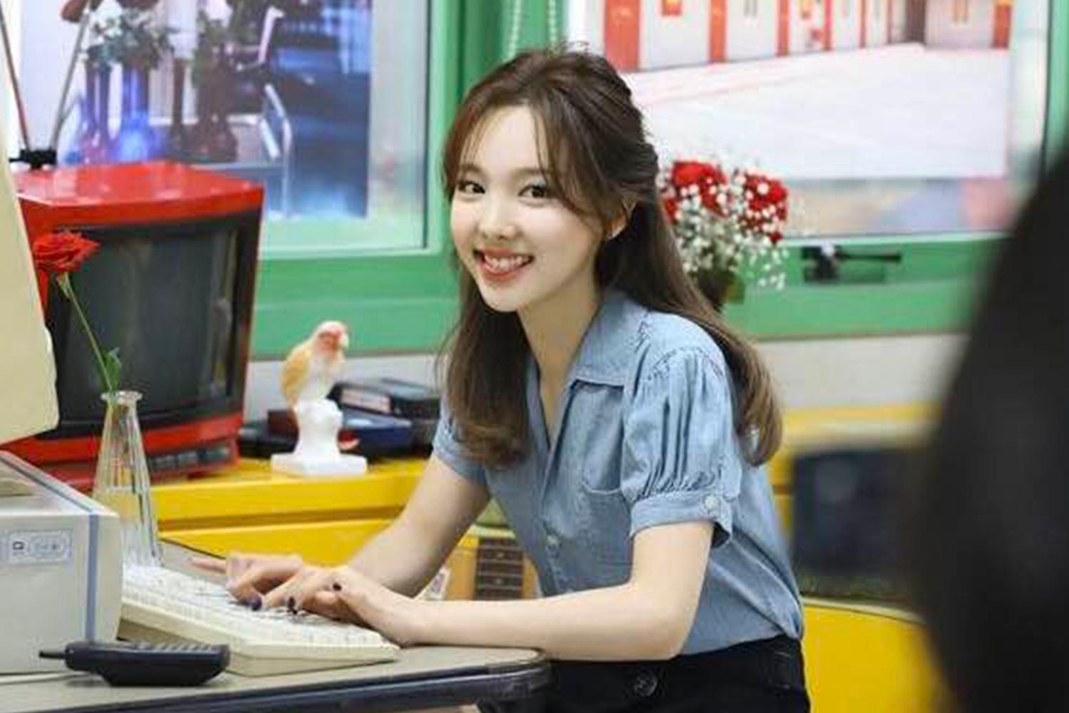 TWICE 成員娜璉為建國大學學生，穿著便服和微笑著看向鏡頭。