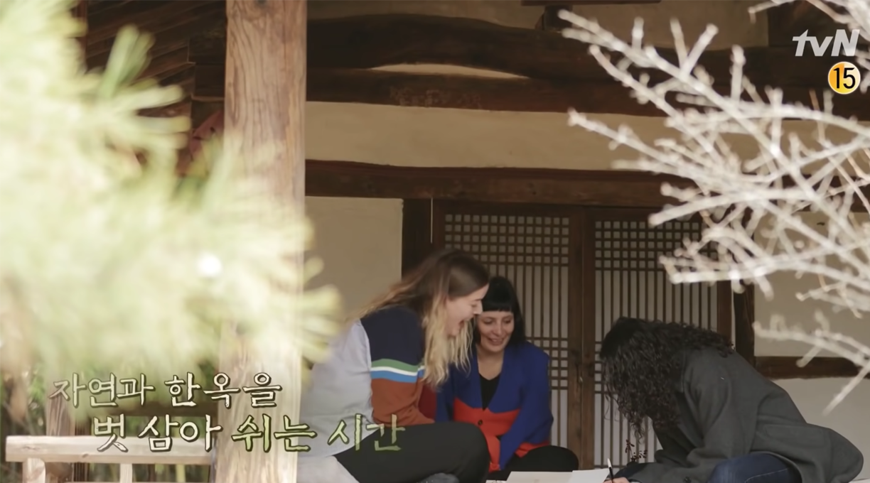 guests of youn stay chatting and writing at a hanok building