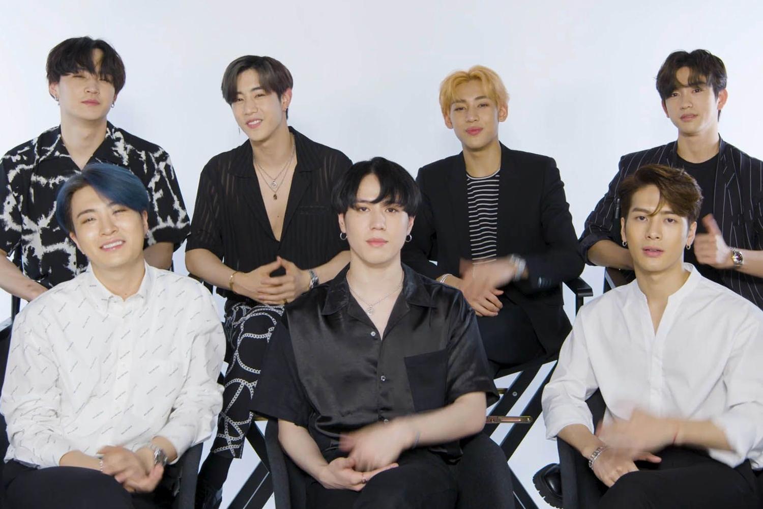 GOT7 멤버 중 한 명이 창문 옆에 서서 밖을 보는 모습