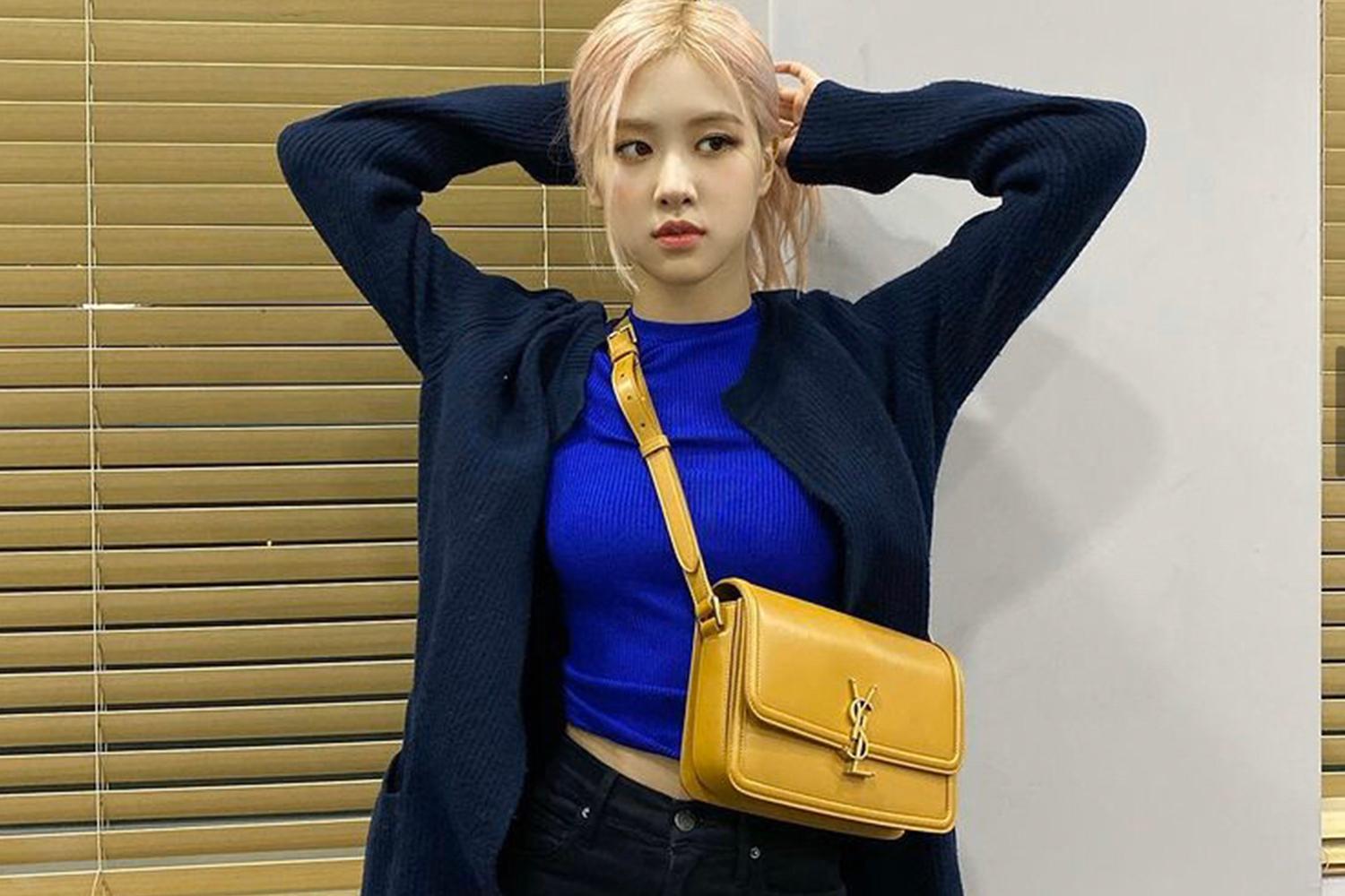 時尚日常搭配:深藍色開襟毛衣內搭亮藍色短上衣,且配有亮黃色肩揹包,顯現個性出眾風格。