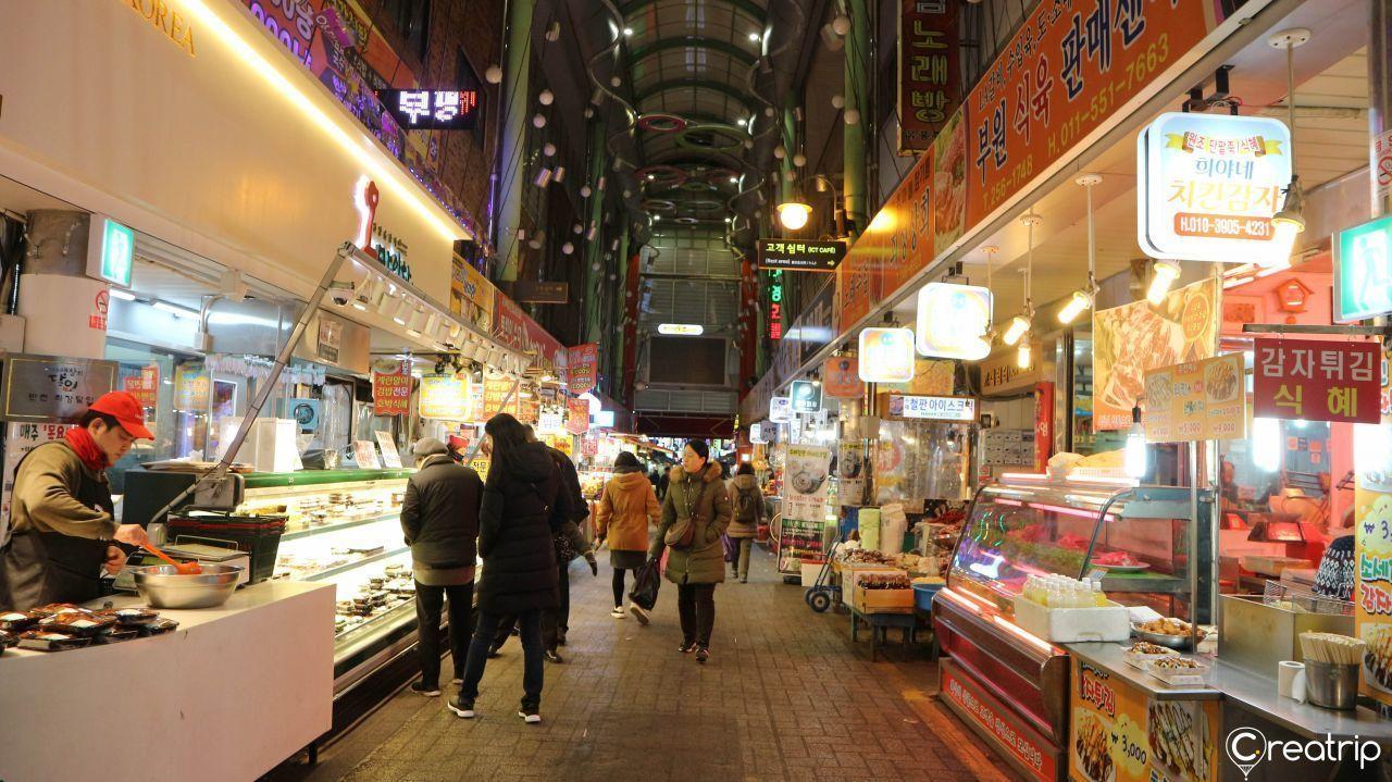 Bupyeong Market stalls, offering a quaint nighttime shopping experience with various food and merchandise.