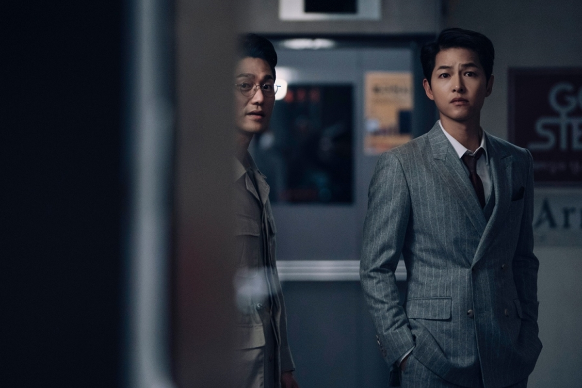 Vincenzo and his co-worker looking over towards this way, looking serious on Vincenzo